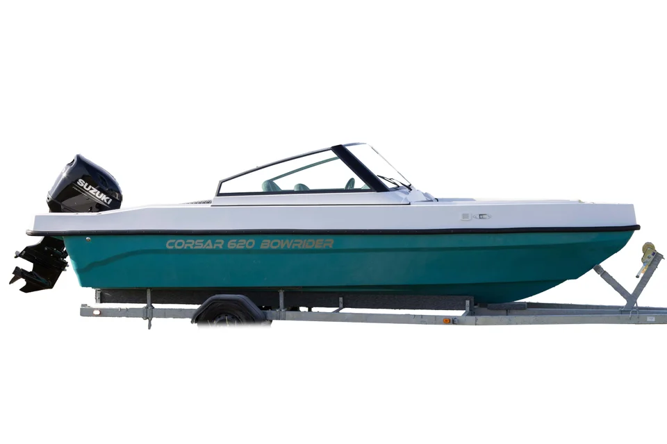 White and turquoise boat with an outboard, side view White and turquoise boat with an outboard, side view